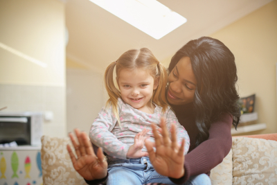 African American women sitting with little girl in sofa