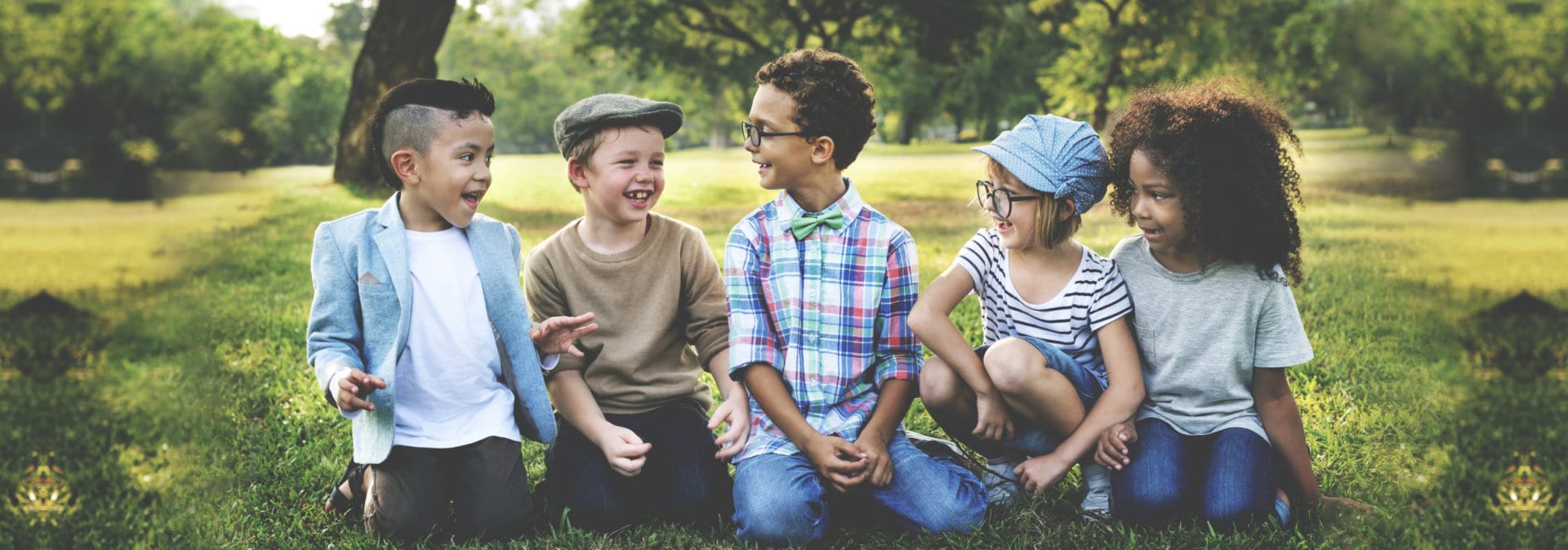Group of kids look happy sitting on the grass
