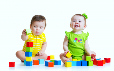 Two adorable babies kids playing with educational toys